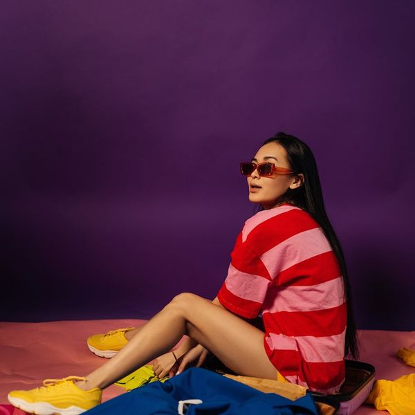 A man stretching, feeling revitalized and full of energy against a vibrant background.